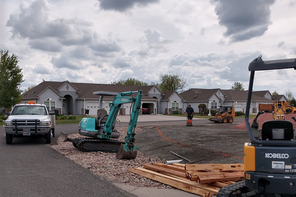 view of an excavator and other machines parked at the project site